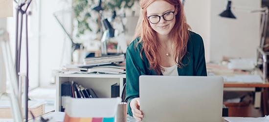 Woman using USPS online customs forms tool on her laptop